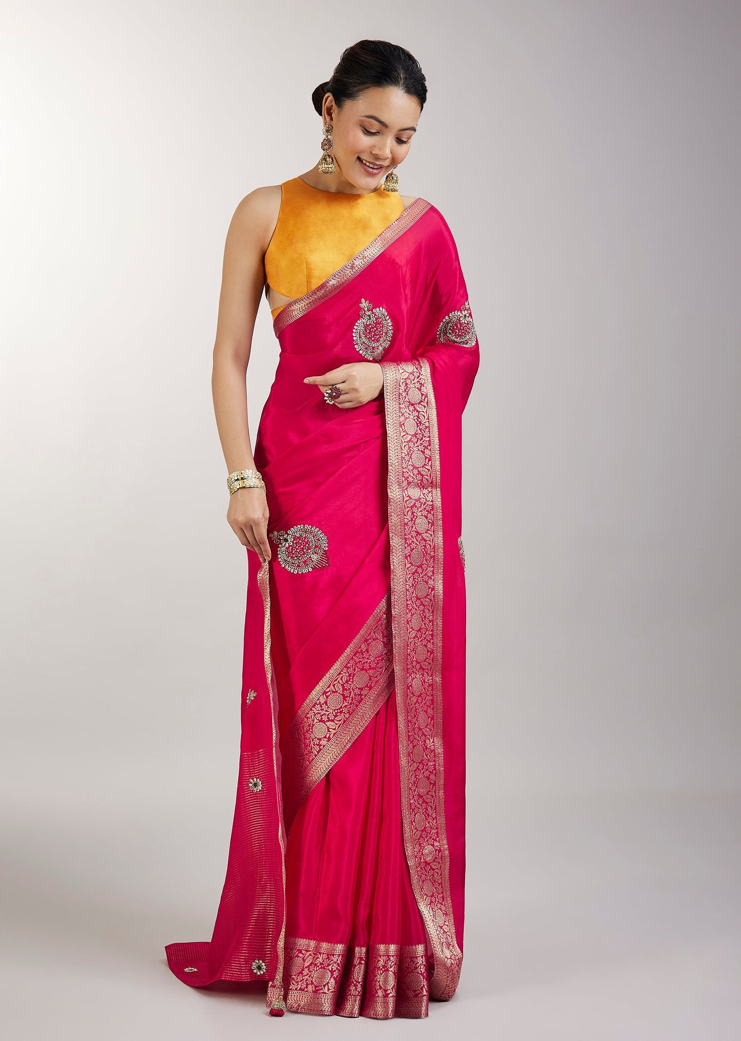 Rani Pink Crepe Saree With Embroidered Butti And Zari Border