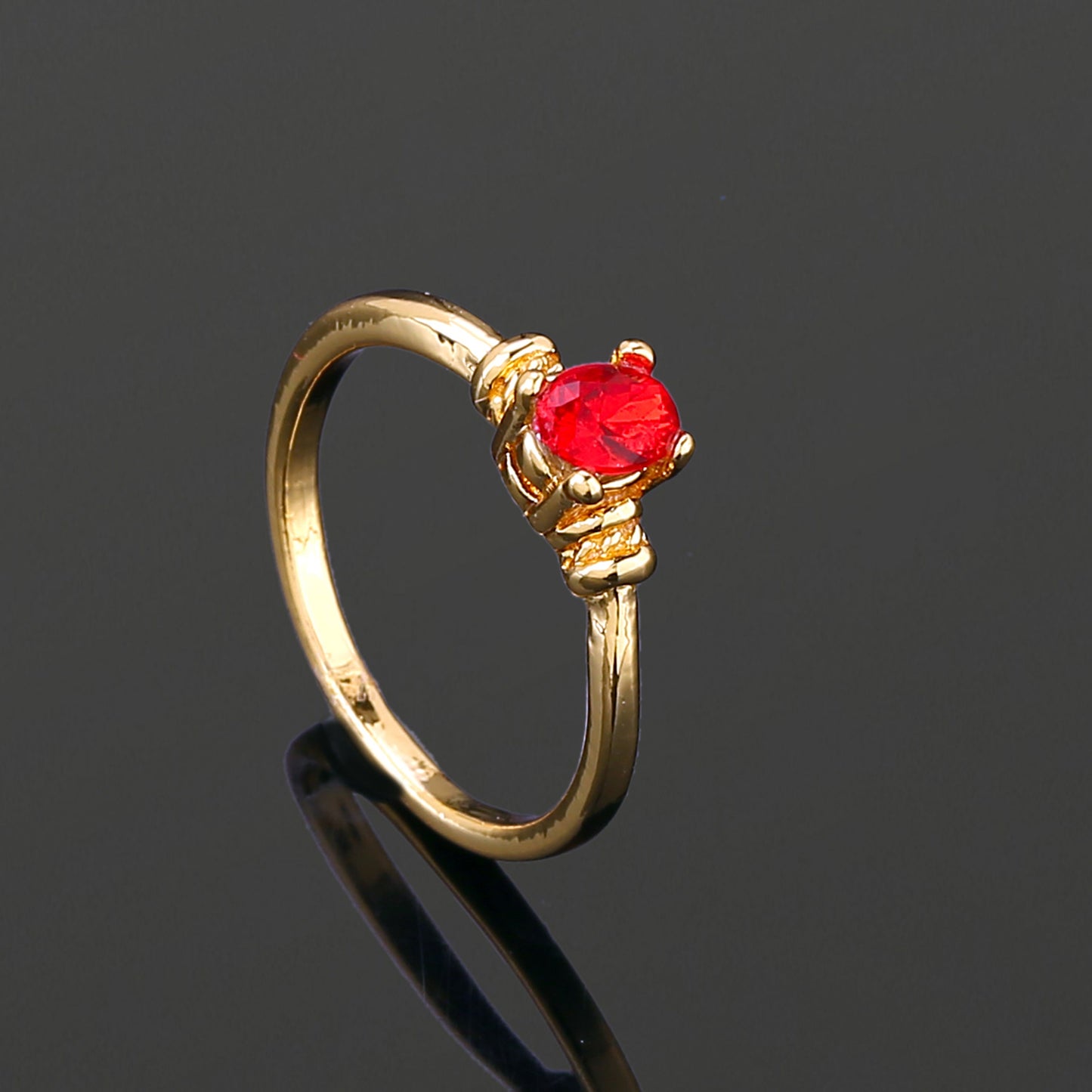 Estele Gold Plated Oval Shaped Finger Ring with Red Crystals for Women