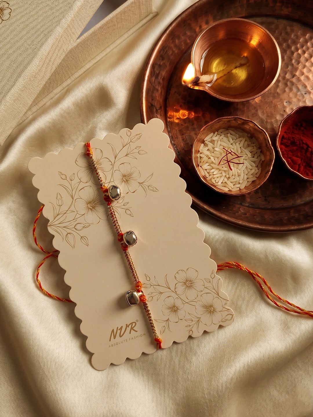 NVR Golden Ghungroo Thread Rakhi with Roli Chawal Chandan Mishri