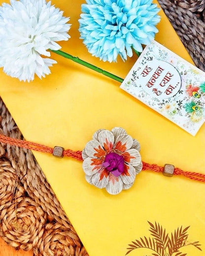 NVR Multicolor Floral Design Plant Seed Rakhi with Roli Chawal Chandan Mishri