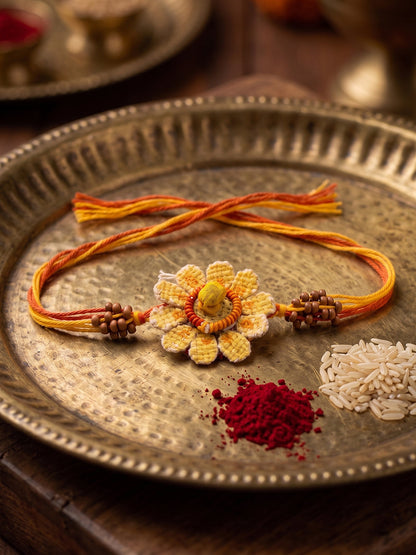 NVR Yellow Floral Seed Thread Rakhi with Roli Chawal Chandan Mishri