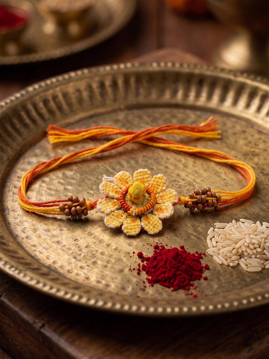NVR Yellow Floral Seed Thread Rakhi with Roli Chawal Chandan Mishri