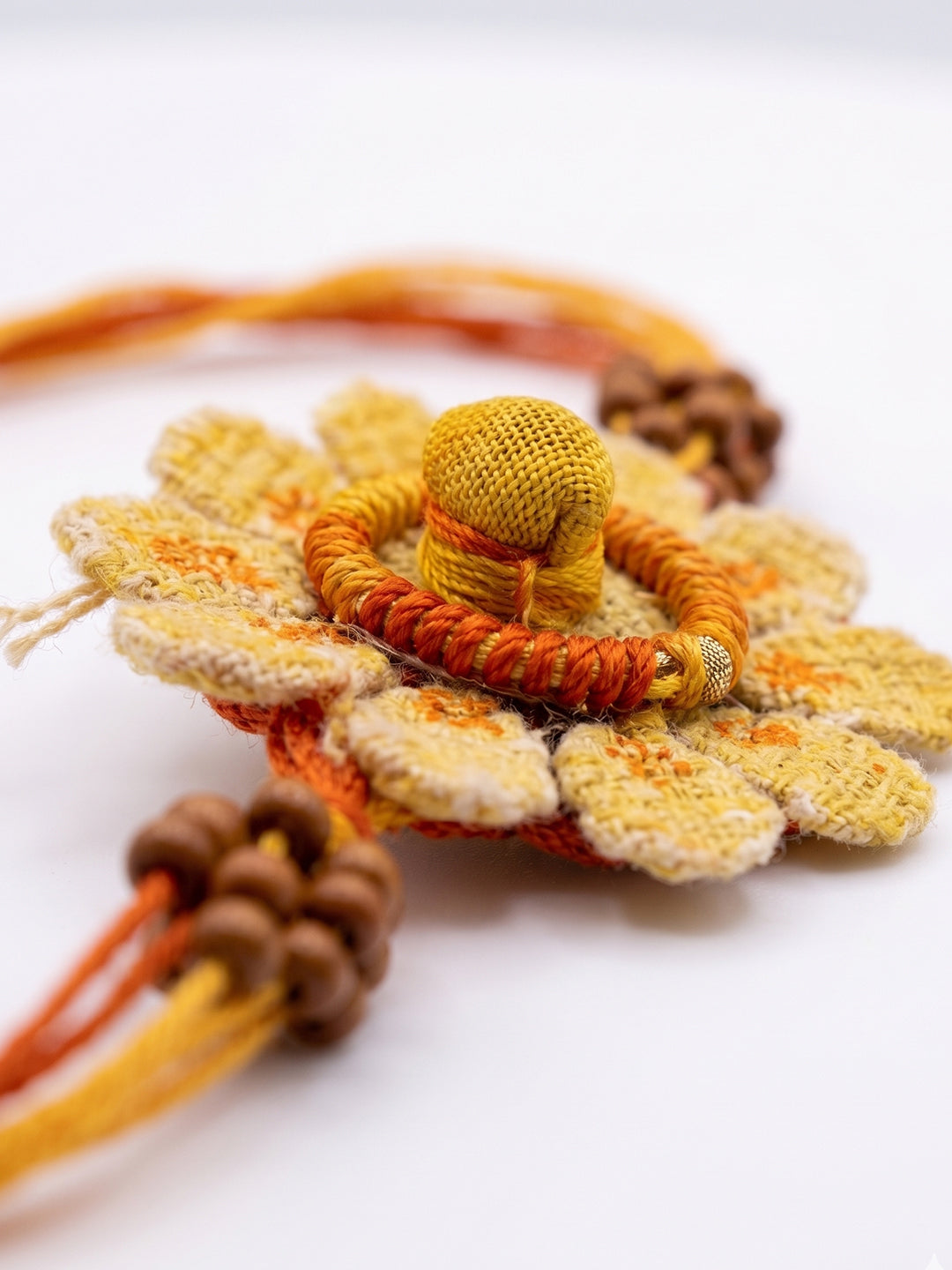 NVR Yellow Floral Seed Thread Rakhi with Roli Chawal Chandan Mishri