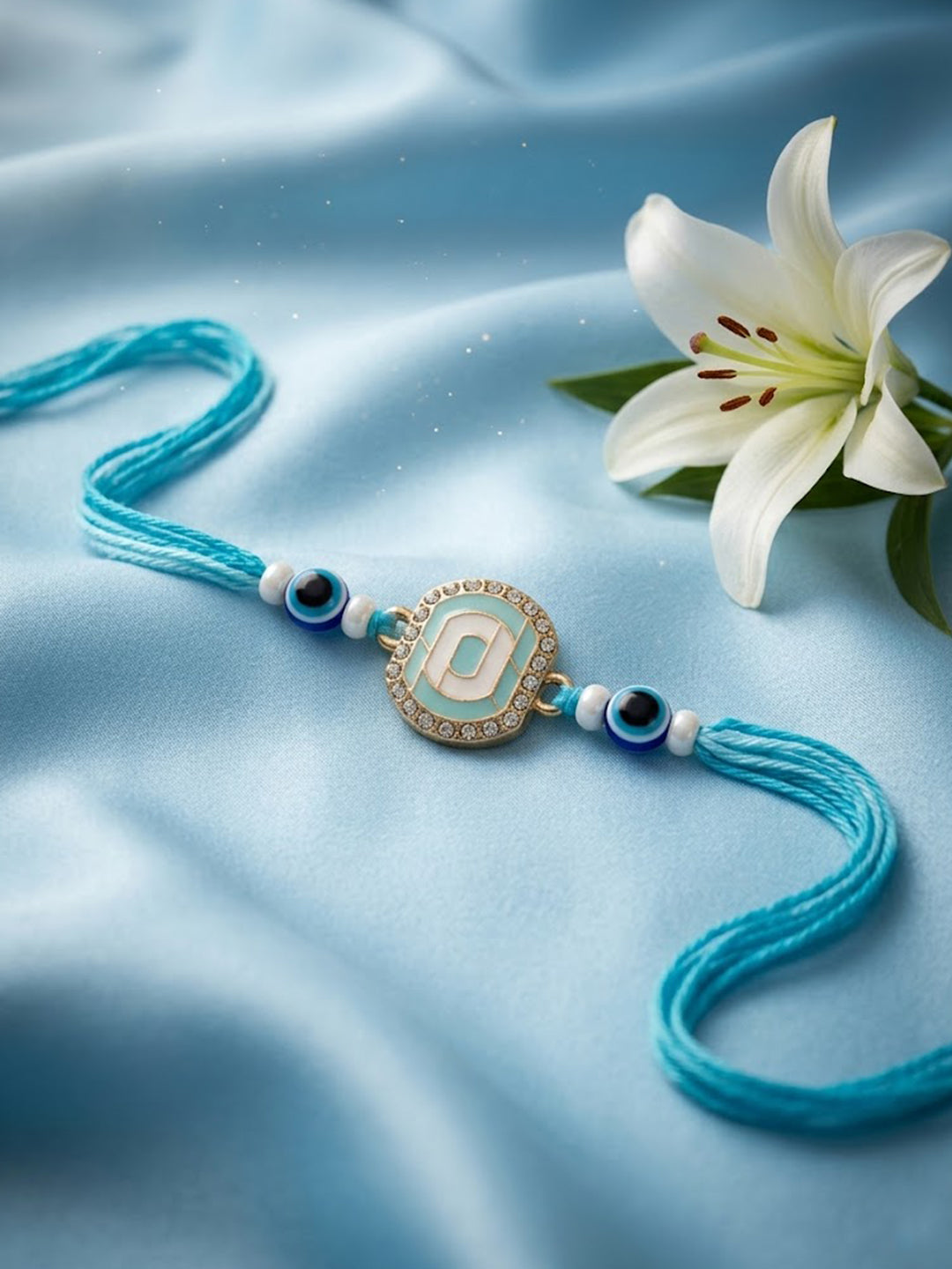 NVR Blue Evil Eye & Artificial Stones Oval Shape Thread Rakhi with Roli Chawal Chandan