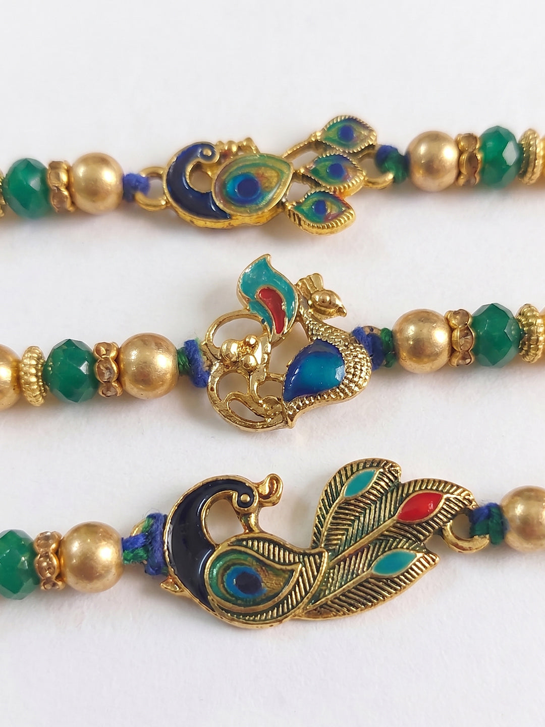 NVR Set of 3 Peacock Design Multicolor Artificial Beads Thread Rakhi With Roli Chawal