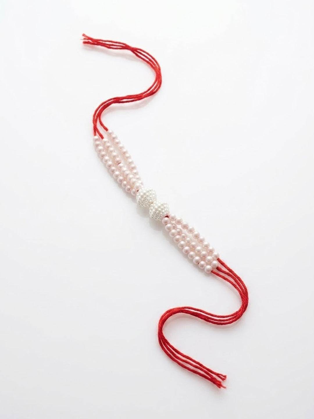 NVR White Pearls & Red Thread Rakhi with Roli Chawal Chandan Mishri