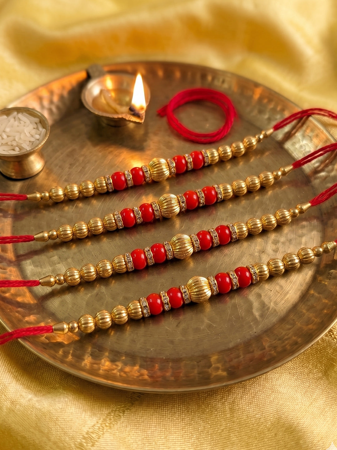 NVR Set of 4 Artificial Beads Red Thread Rakhi With Roli Chawal Chandan Mishri
