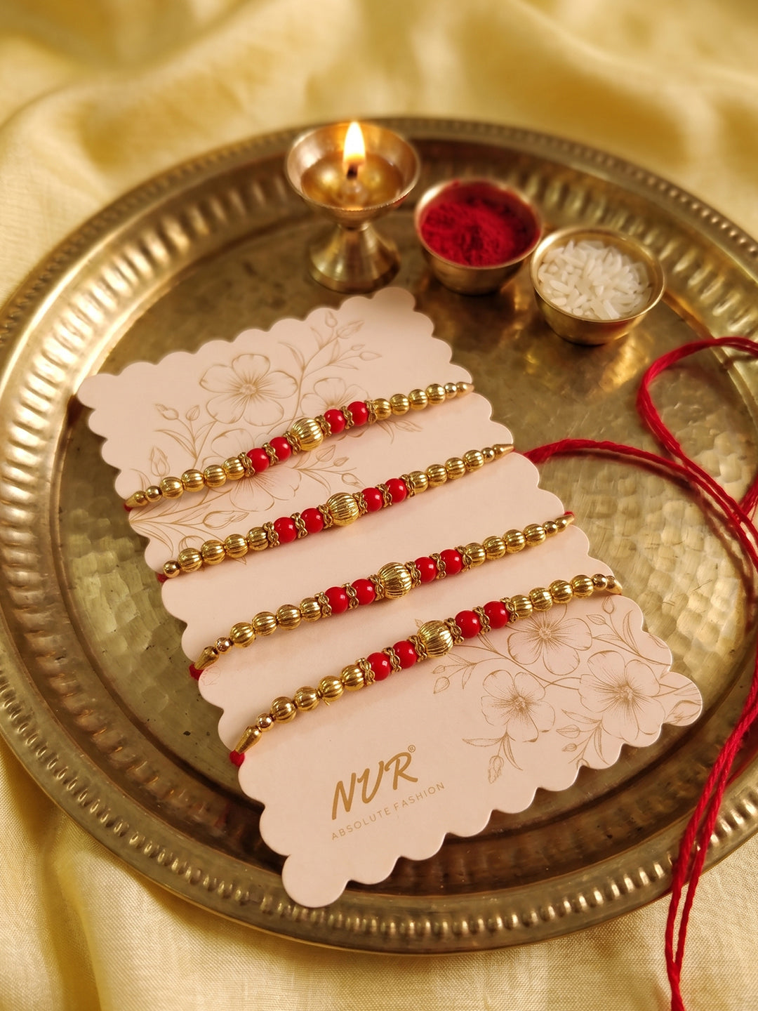 NVR Set of 4 Artificial Beads Red Thread Rakhi With Roli Chawal Chandan Mishri