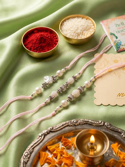 NVR Set of 3 White Pearls Thread Rakhi with Roli Chawal Chandan Mishri