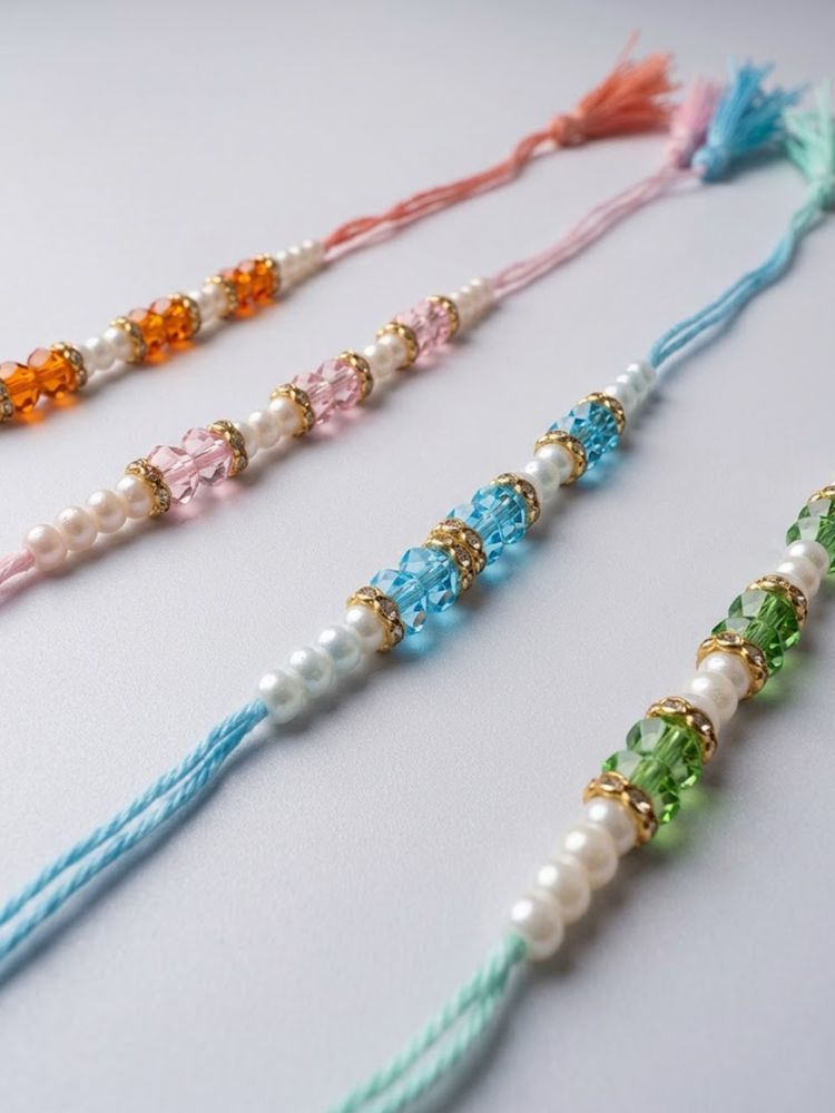 NVR Set of 4 White Pearls & Multicolor Thread Rakhi With Roli Chawal Chandan Mishri