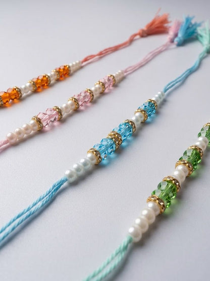 NVR Set of 4 White Pearls & Multicolor Thread Rakhi With Roli Chawal Chandan Mishri