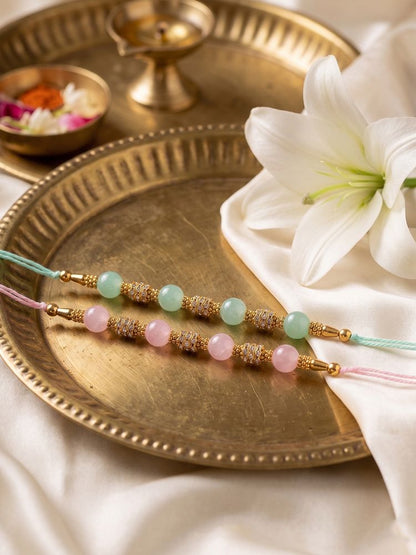 NVR Set of 2 Pink & Green Artificial Beads Thread Rakhi With Roli Chawal Chandan Mishri