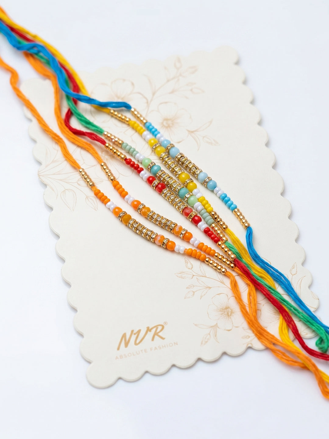 NVR Set of 6 Multi Artificial Beads Thread Rakhi with Roli Chawal Chandan Mishri