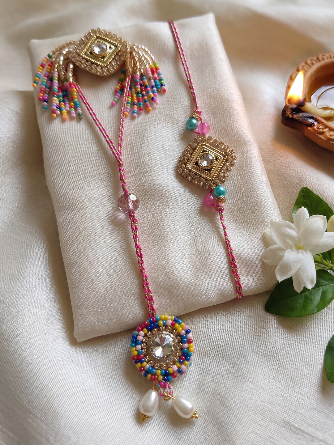 NVR Set of 2 White Artificial Stones Golden Toned Bhaiya Bhabhi Rakhi With Roli Chawal