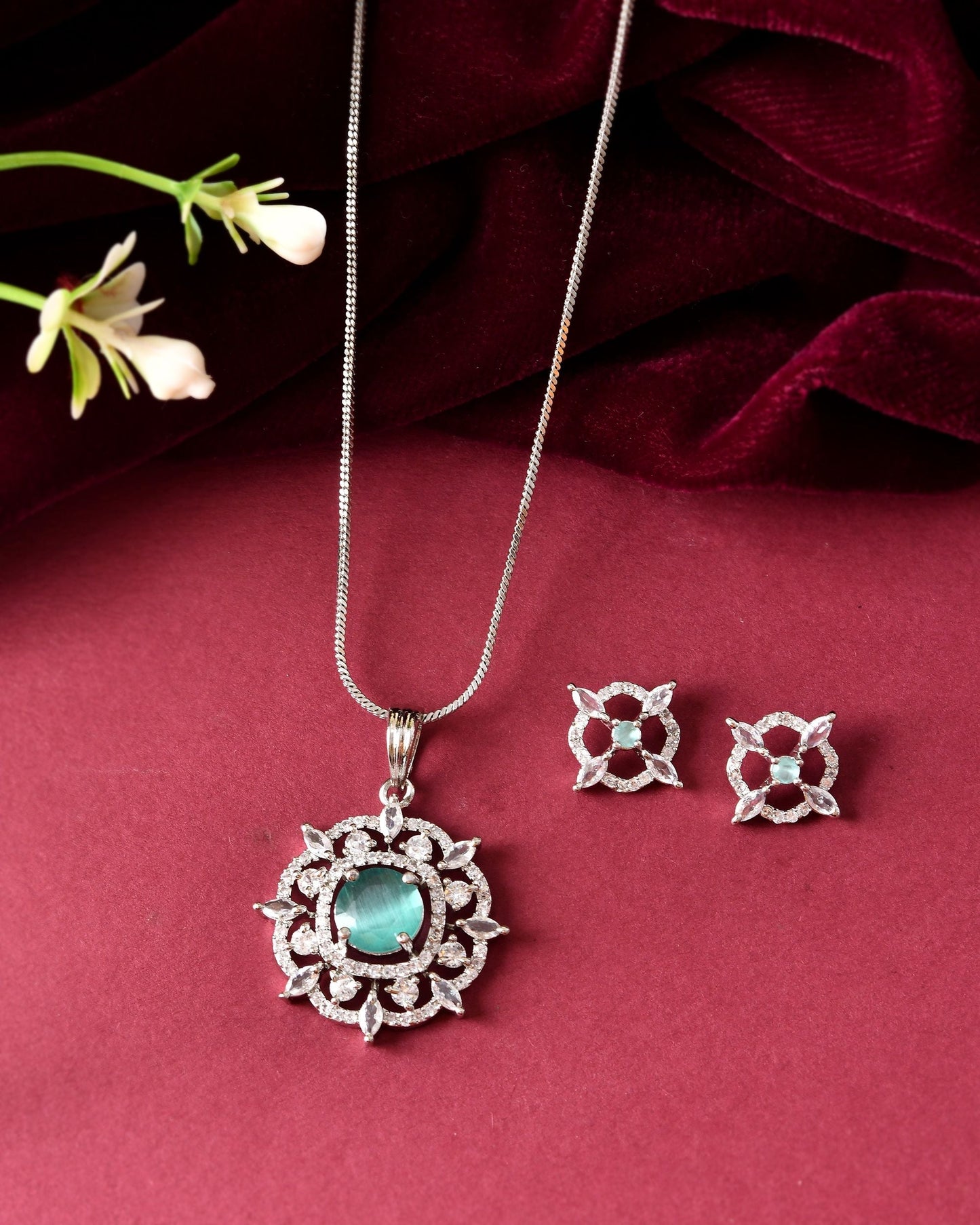 VOJ Silver Plated Sea Green Circulare Stone Studded Sun Shaped Ad Pendant With Chain Set