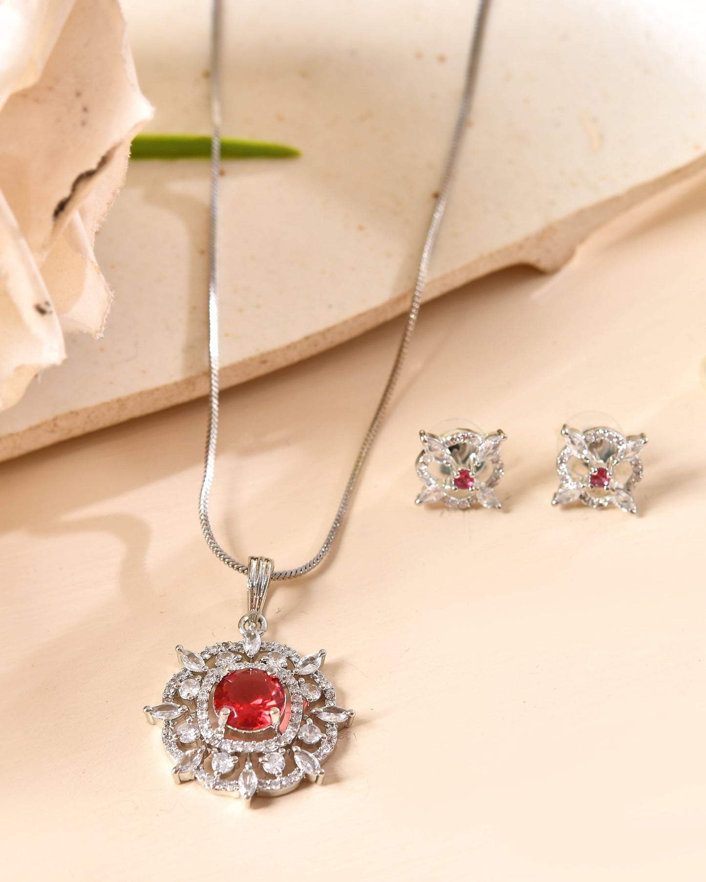 VOJ Silver Plated Ruby Red Circular Stone Studded Sun Shaped Ad Pendant With Chain Set