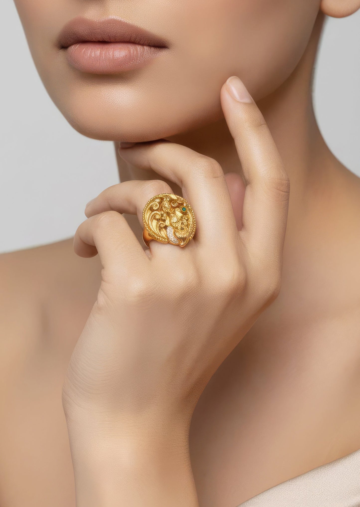Gold Finish Ring With Temple Style Motifs And Green Simulated Stones