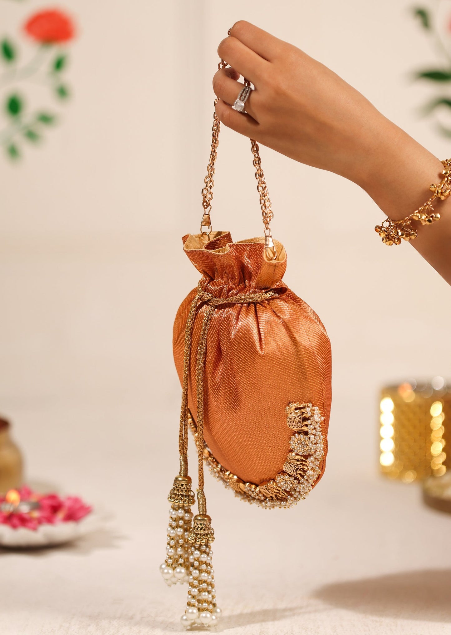 Orange Brocade Potli With Gold Embellishments