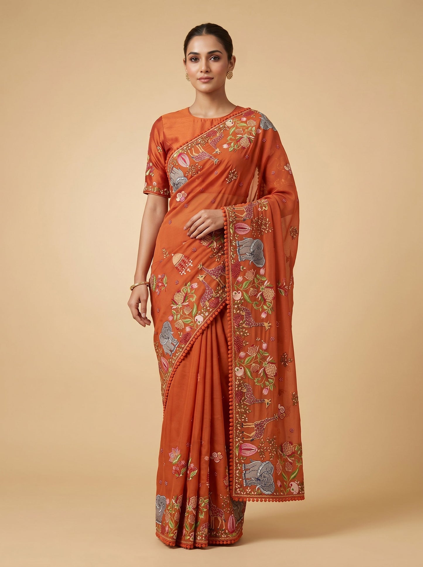 Orange embroidered saree with traditional design