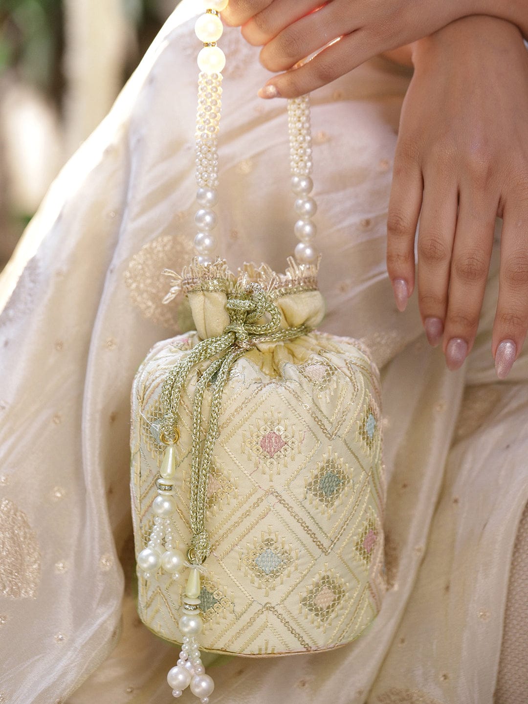 Rubans Cream Potli Bag with Multicolor Pastel Embroidery, Pearl Beaded Handle and Golden Tassel Detailing