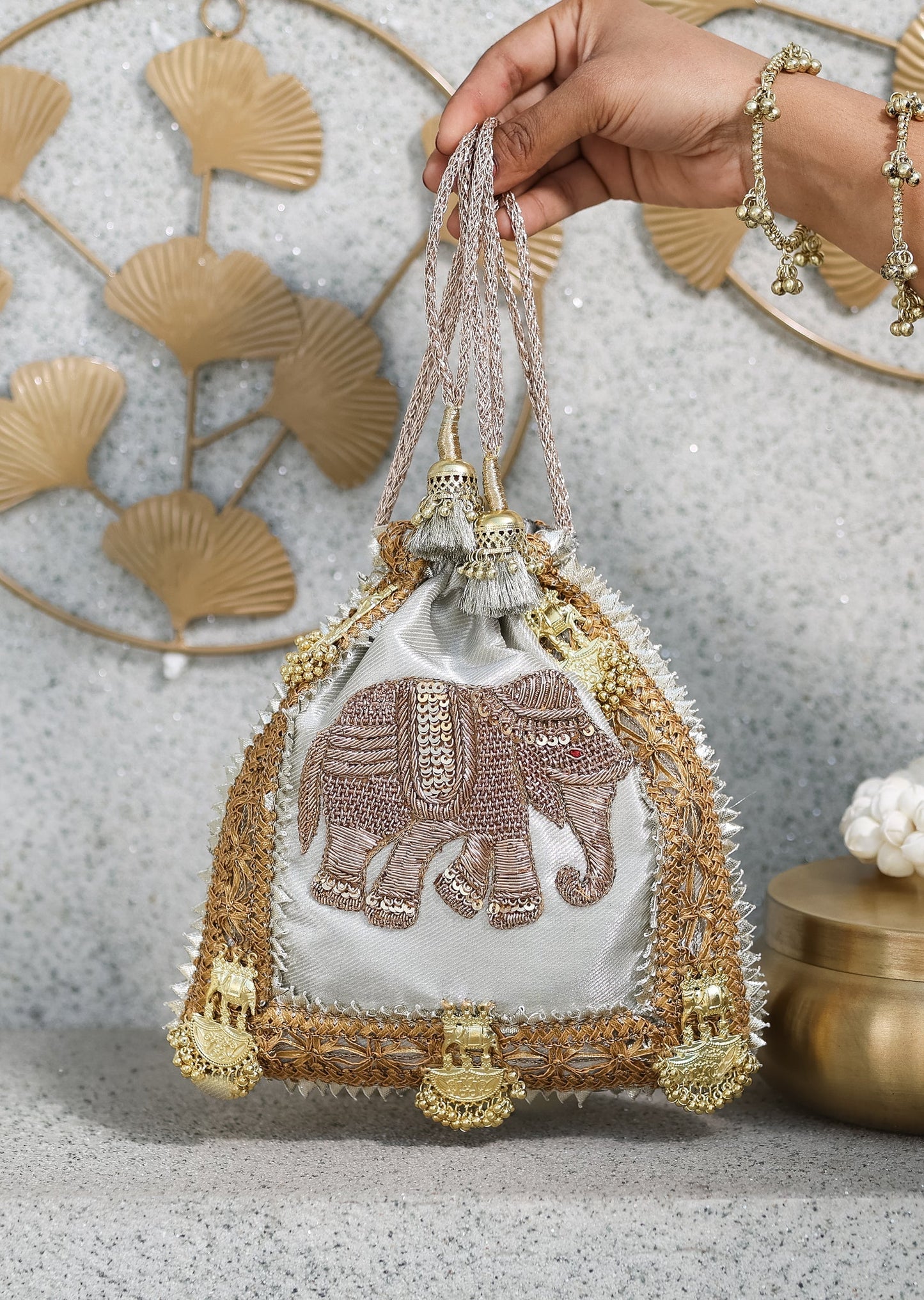 Silver Brocade Potli With Elephant Detailing And Embroidered Embellishments